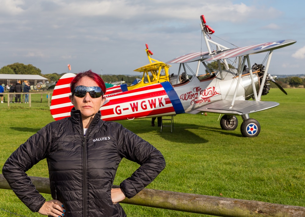 Emma standing in front of the parked Wing Walk plane.